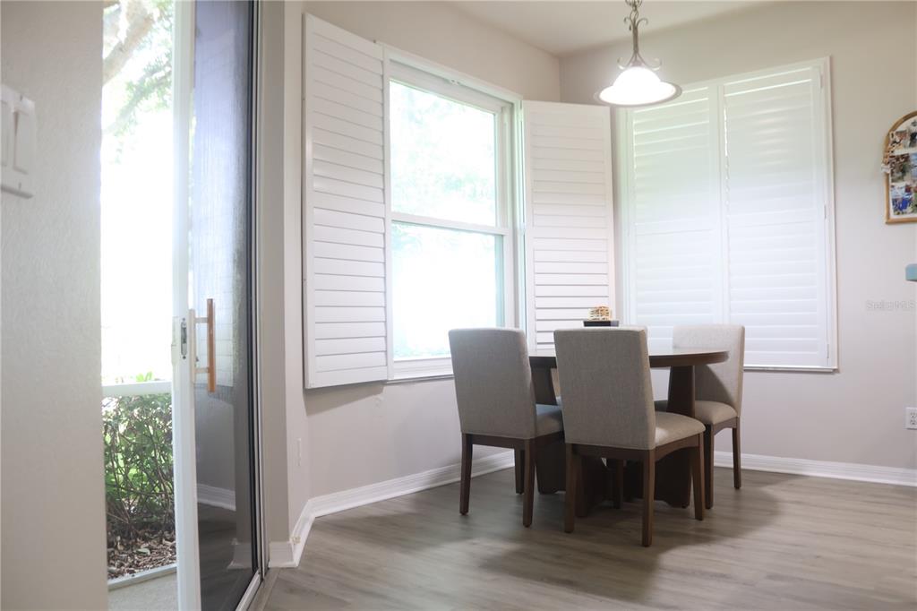 3850 Beacon Ridge Way Clermont, FL 34711 - Photo 32 of 41 a view of a dining room with furniture window and wooden floor