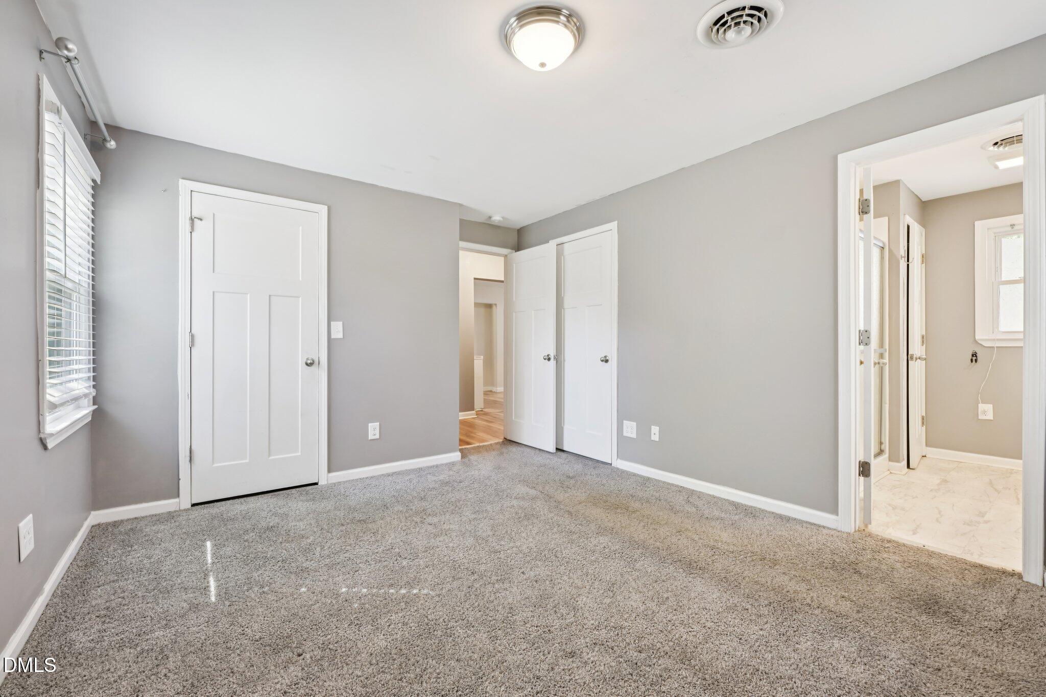 712 Fairground Road Dunn, NC 28334 - Photo 12 of 23 an empty room with windows and closet area