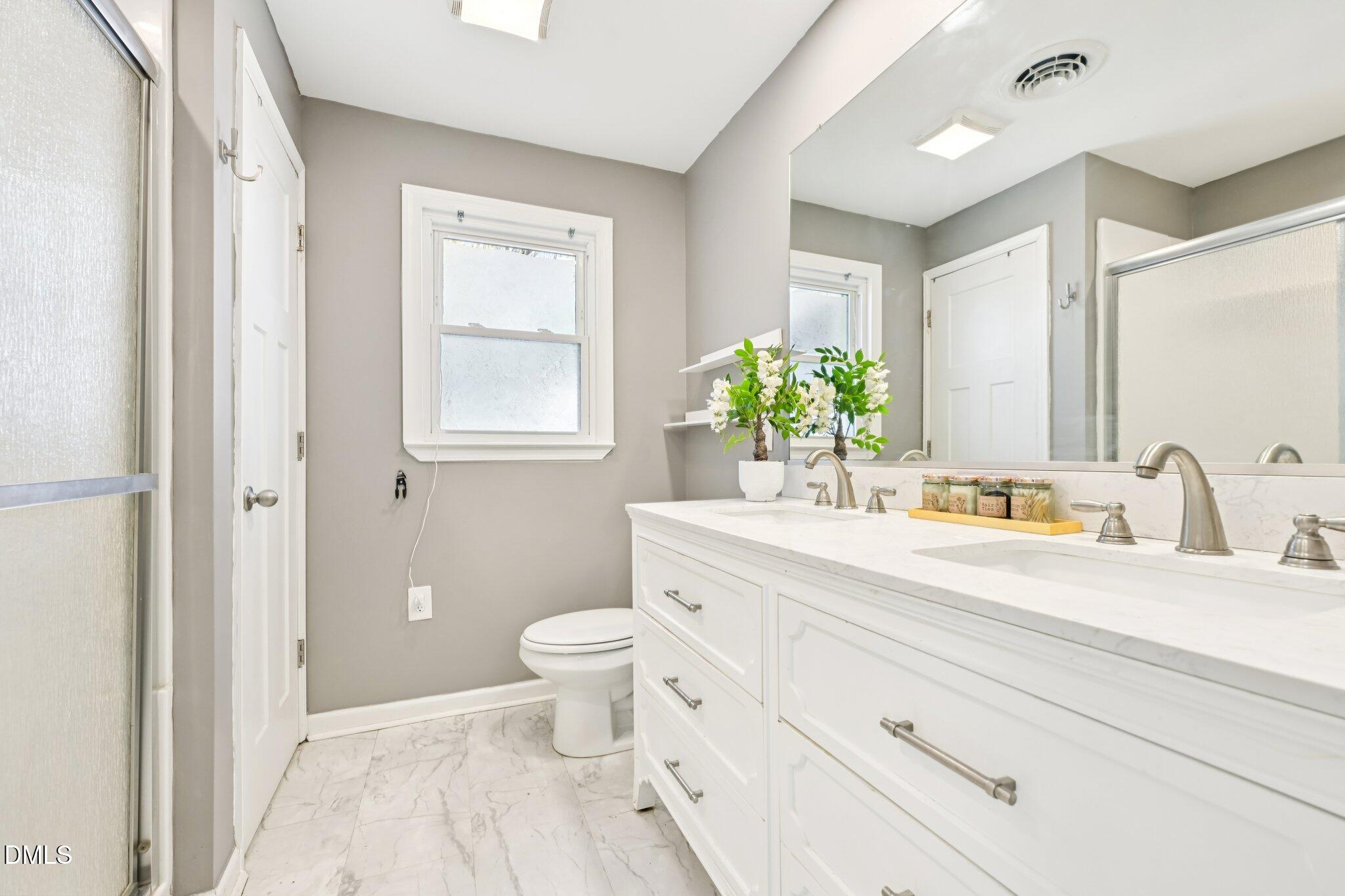 712 Fairground Road Dunn, NC 28334 - Photo 13 of 23 a bathroom with a granite countertop sink mirror vanity and a toilet