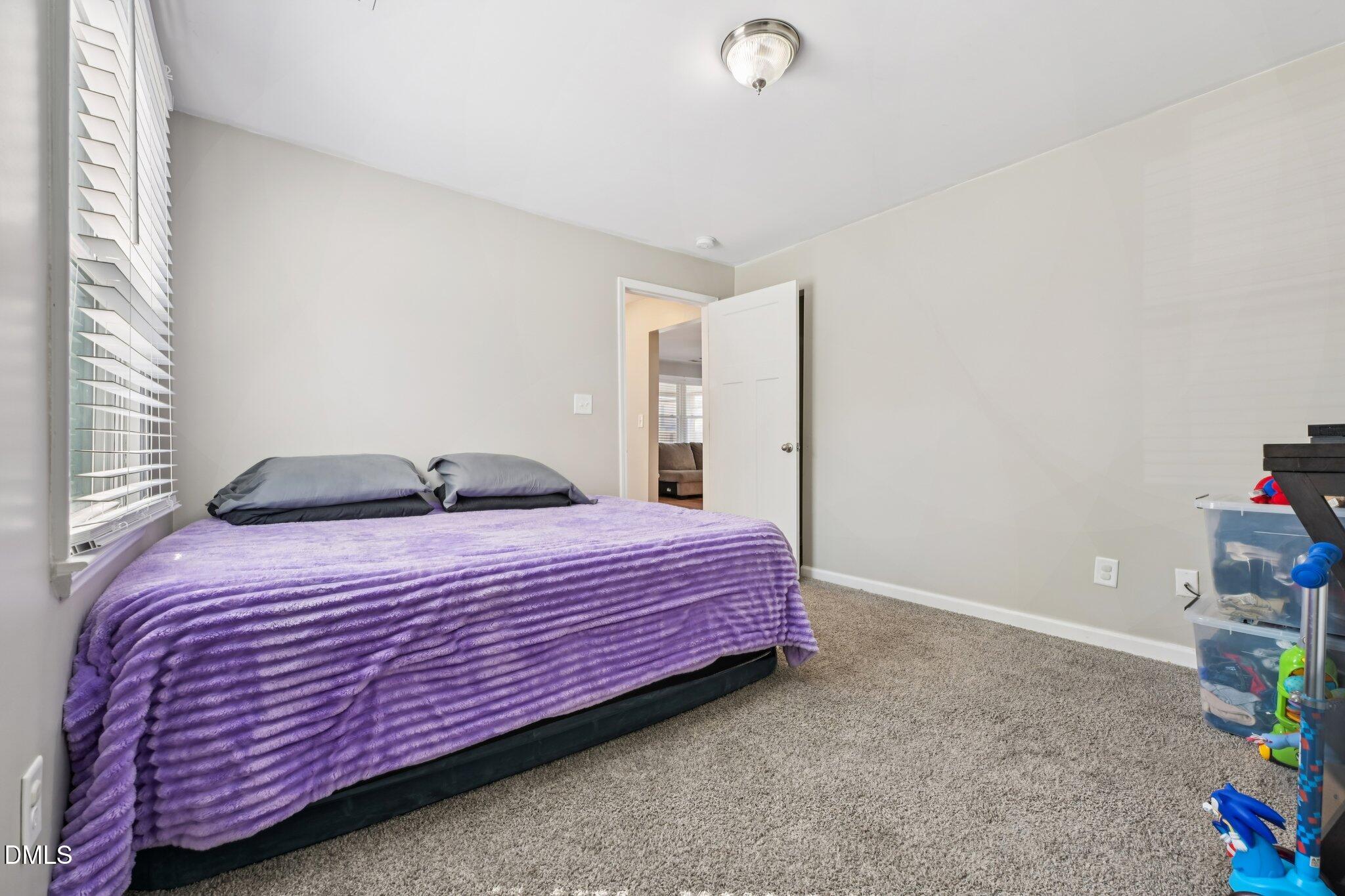 712 Fairground Road Dunn, NC 28334 - Photo 15 of 23 a bedroom with a bed and a window