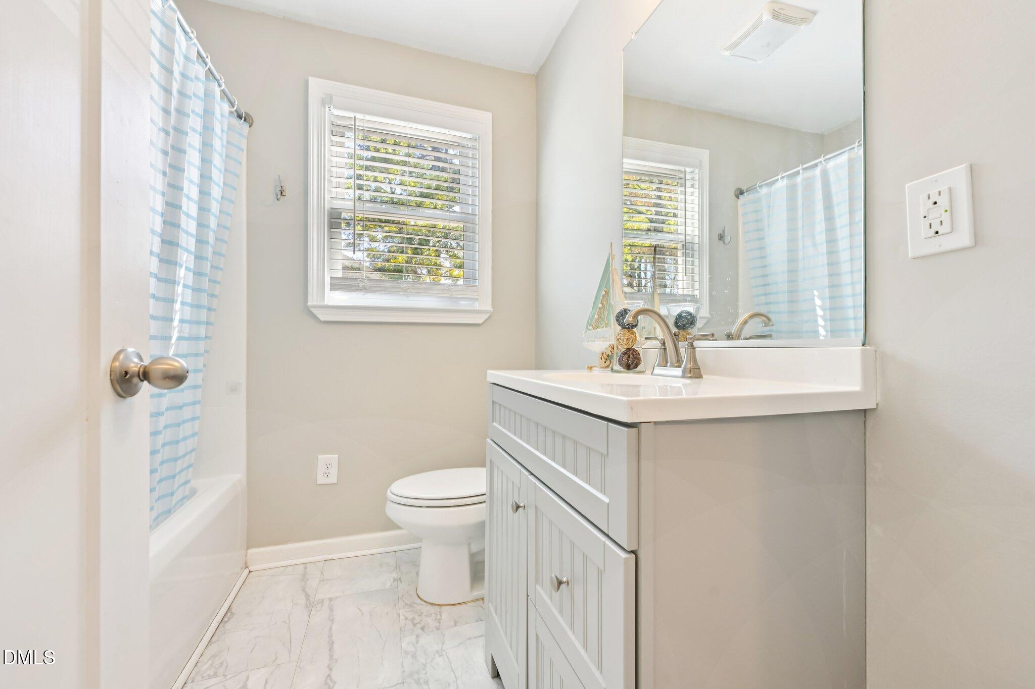 712 Fairground Road Dunn, NC 28334 - Photo 16 of 23 a bathroom with a sink toilet and window