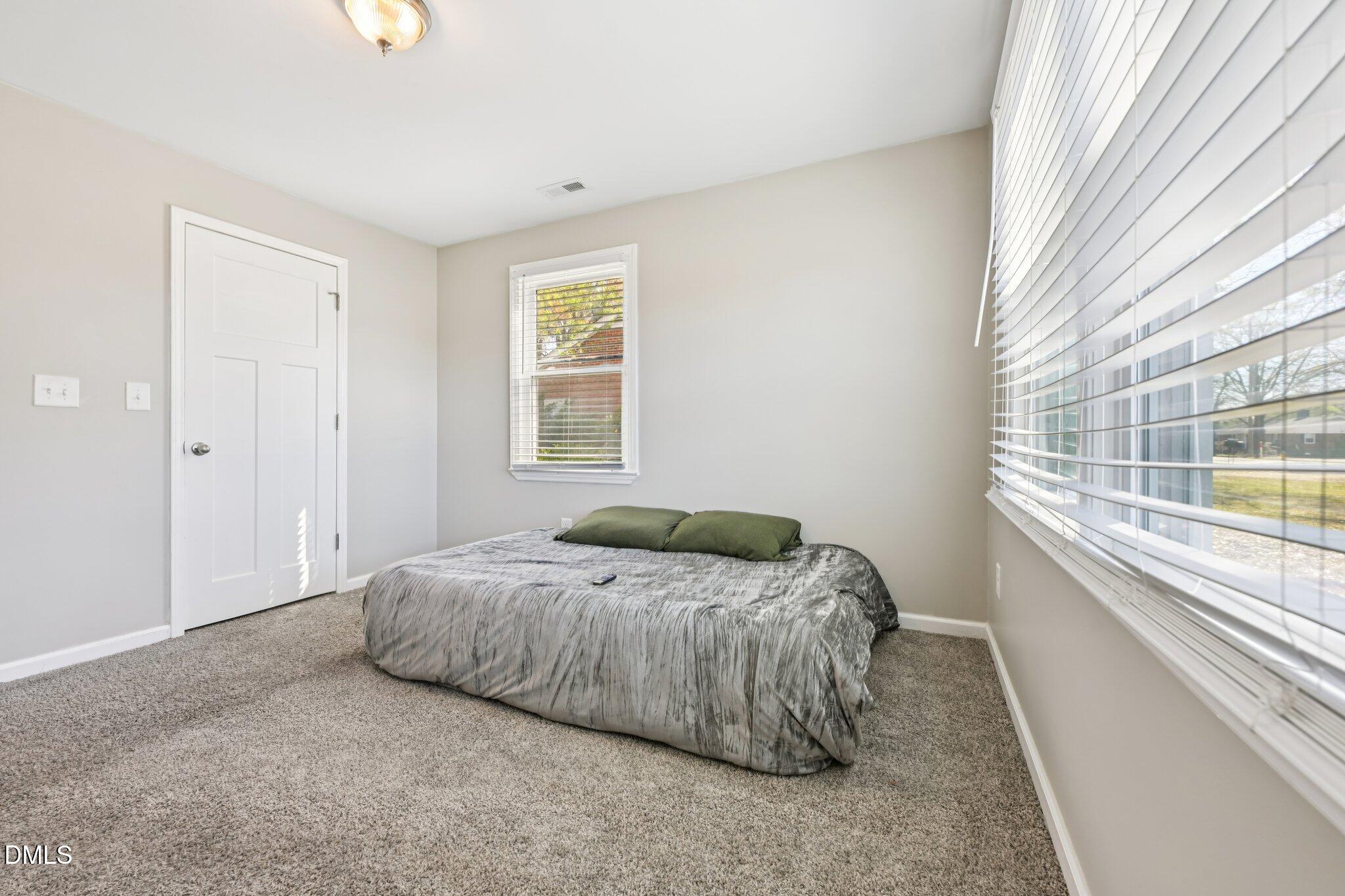 712 Fairground Road Dunn, NC 28334 - Photo 17 of 23 a bedroom with a bed and a window