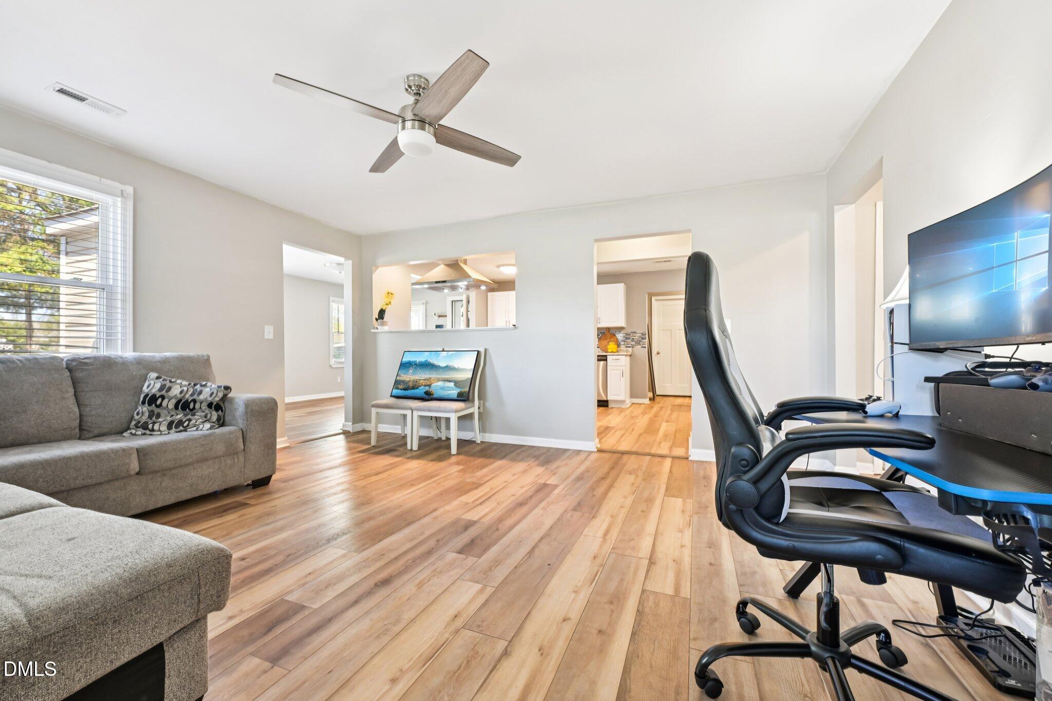 712 Fairground Road Dunn, NC 28334 - Photo 5 of 23 a living room with furniture a flat screen tv and a wooden floor