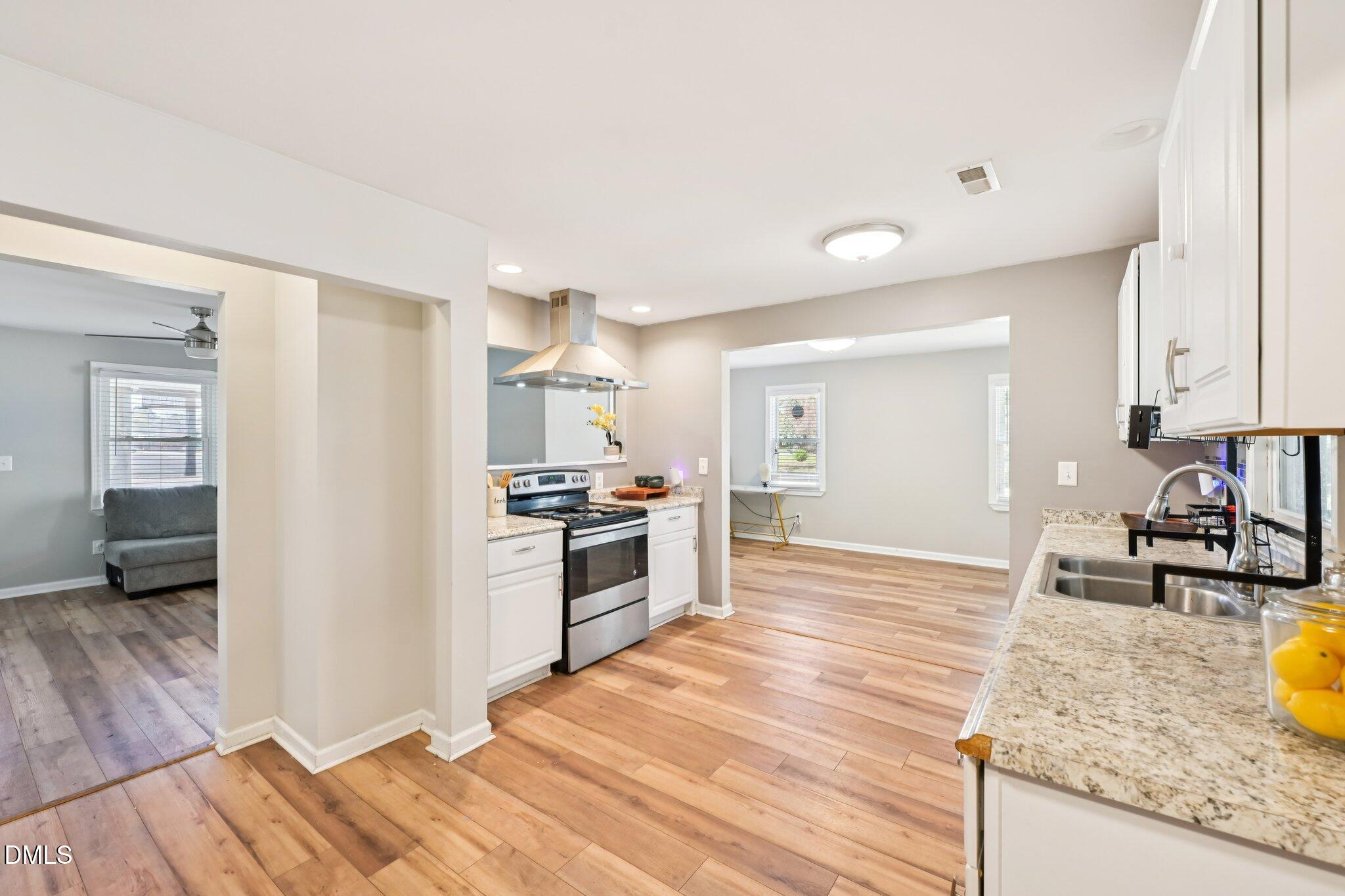 712 Fairground Road Dunn, NC 28334 - Photo 8 of 23 a kitchen with granite countertop a stove and a sink