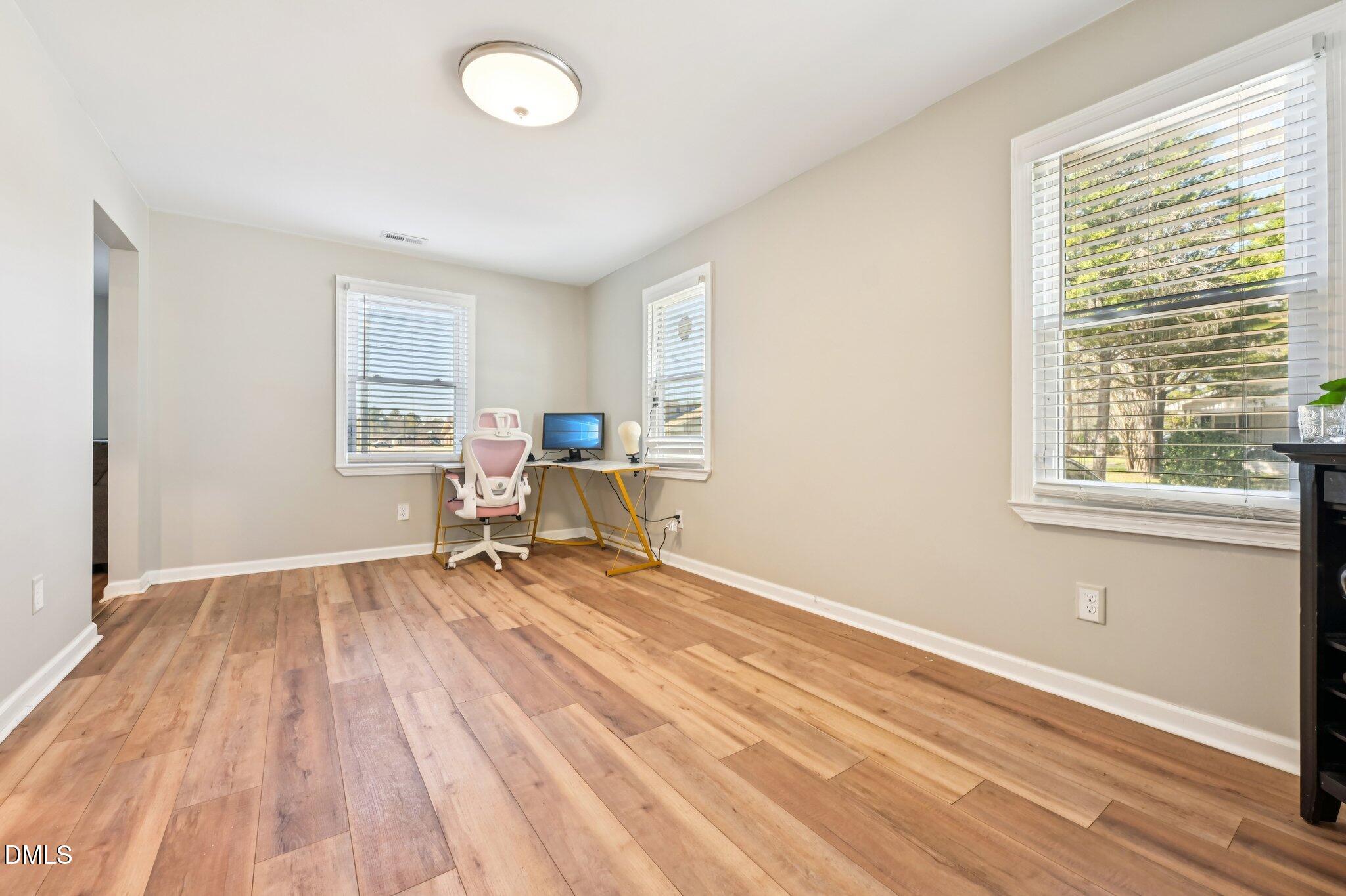 712 Fairground Road Dunn, NC 28334 - Photo 10 of 23 a room with wooden floor and a window