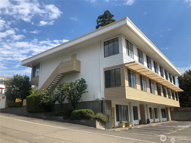 a front view of a house with plants