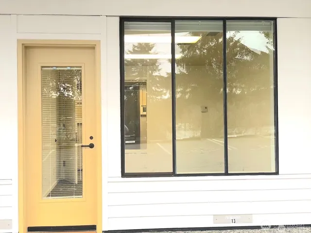 a bathroom with a glass shower door and a window