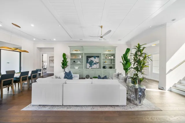 a living room with furniture a flat screen tv and a large window