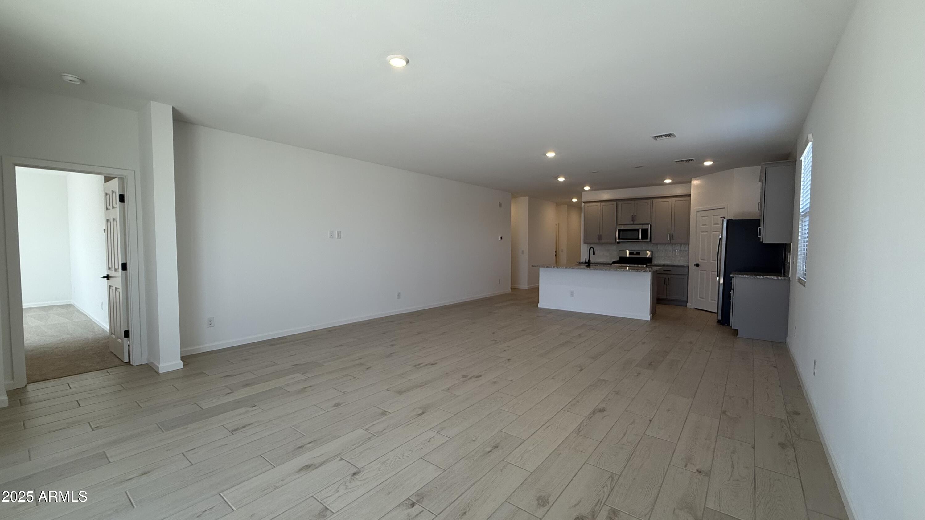 46819 West Old Timer Road Maricopa, AZ 85139 - Photo 13 of 44 a view of a kitchen with a sink and wooden floor