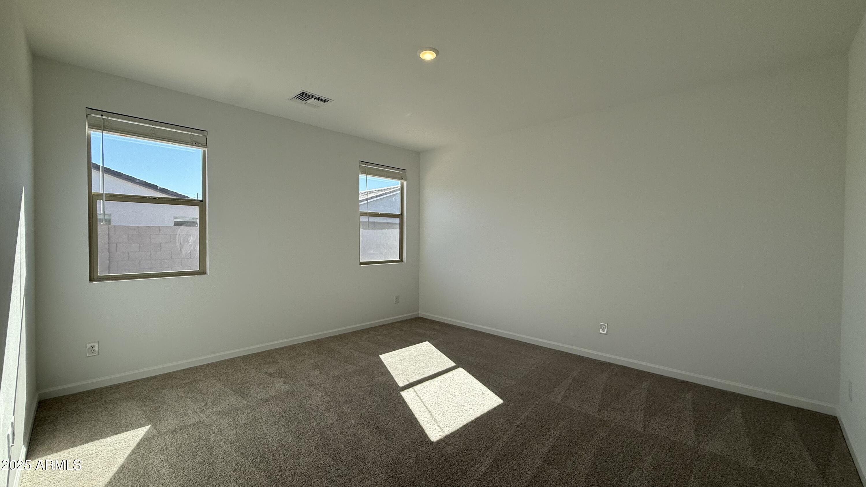 46819 West Old Timer Road Maricopa, AZ 85139 - Photo 17 of 44 an empty room with windows