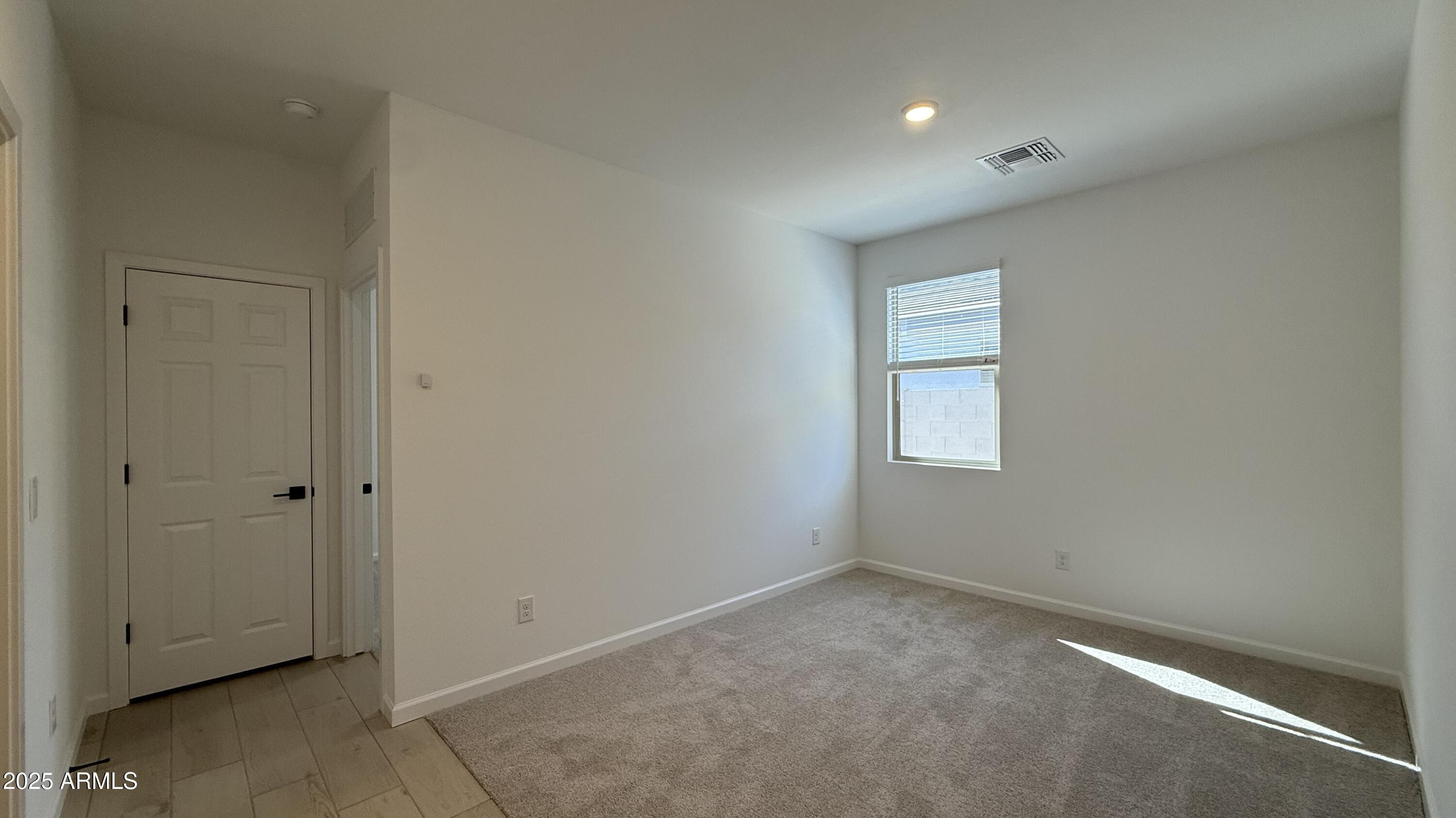 46819 West Old Timer Road Maricopa, AZ 85139 - Photo 23 of 44 an empty room with windows and closet