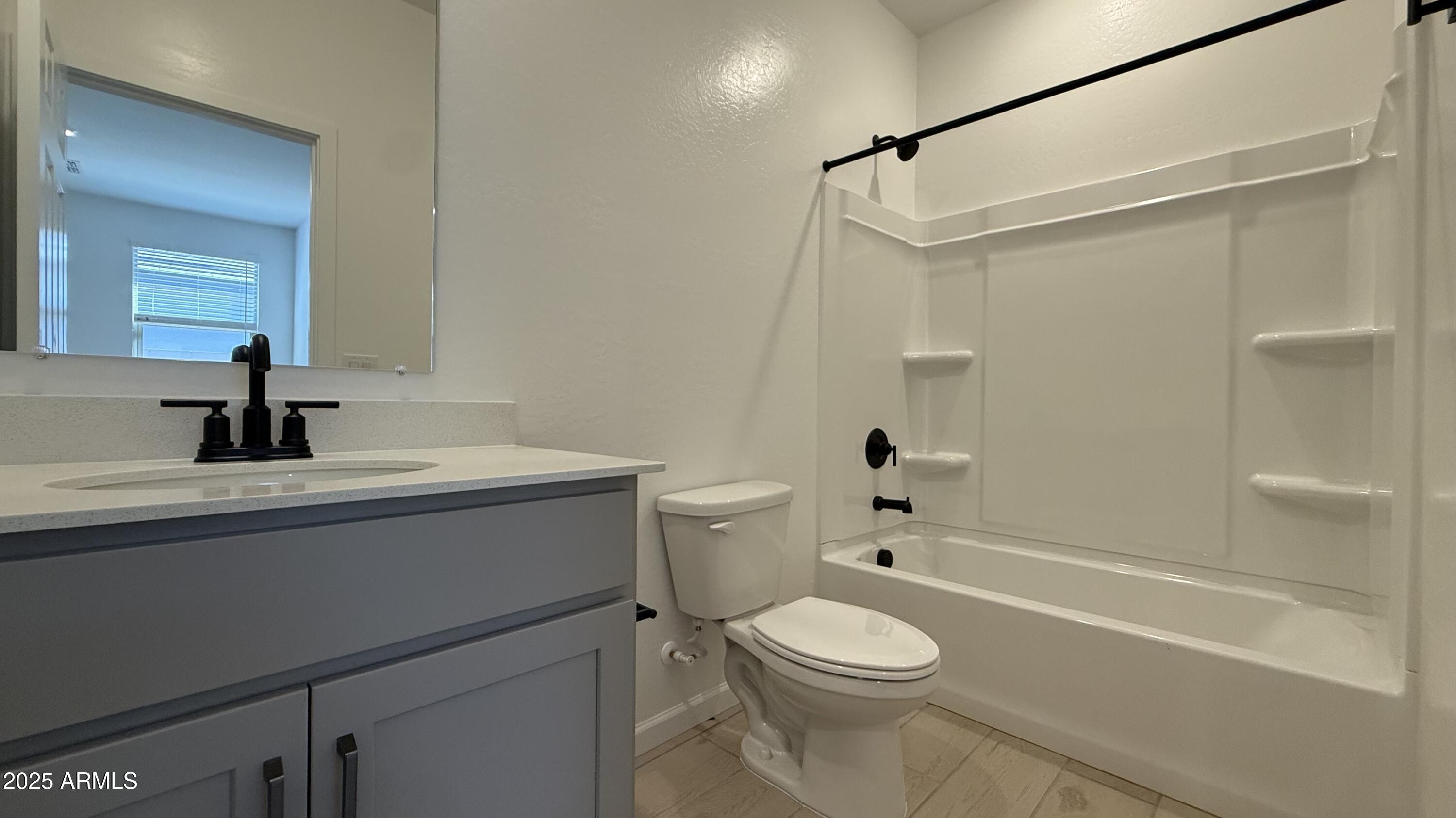 46819 West Old Timer Road Maricopa, AZ 85139 - Photo 25 of 44 a bathroom with a sink a toilet and shower