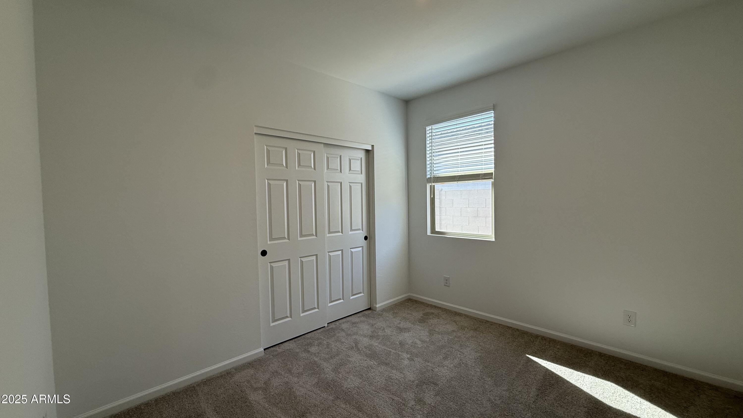 46819 West Old Timer Road Maricopa, AZ 85139 - Photo 26 of 44 an empty room with windows