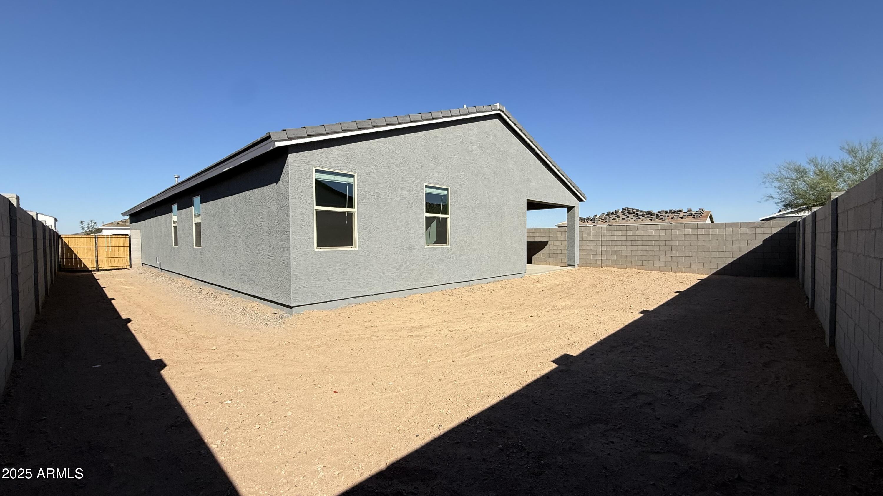 46819 West Old Timer Road Maricopa, AZ 85139 - Photo 31 of 44 a backyard of a house with wooden fence