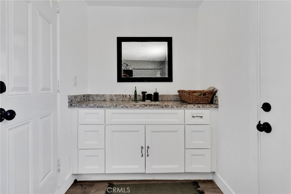 15471 Washoan Road Apple Valley, CA 92307 - Photo 26 of 38 a bathroom with a sink and a mirror