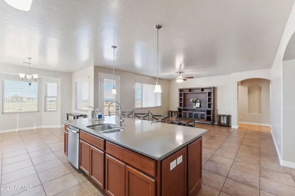a kitchen with kitchen island a sink a counter and chairs