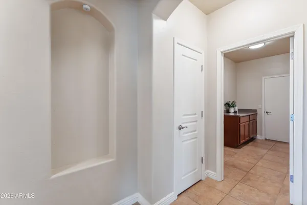 a view of a hallway to closet and a mirror