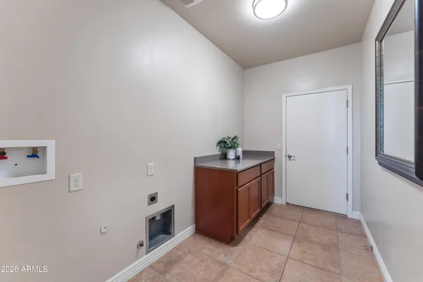 a utility room with cabinets washer and dryer