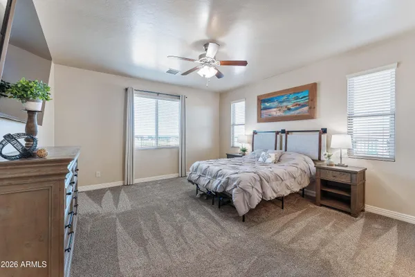 a spacious bedroom with a bed and a window