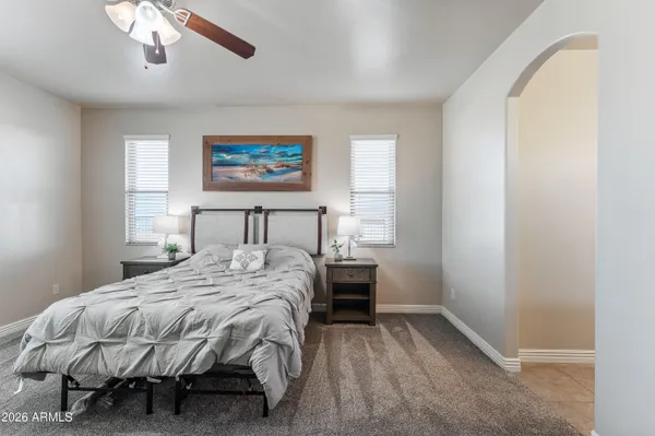 a bedroom with a bed and a painting on the wall
