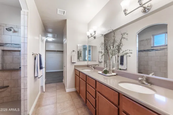 a bathroom with a double vanity sink shower and a mirror