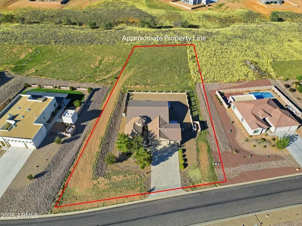 an aerial view of a house with a garden and lake view