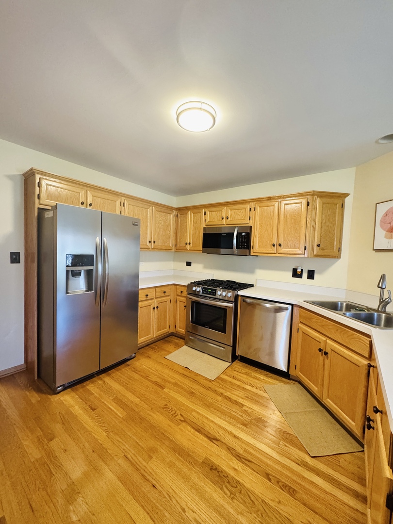 19245 Tramore Lane Mokena, IL 60448 - Photo 7 of 21 a large kitchen with stainless steel appliances a stove a sink and a refrigerator