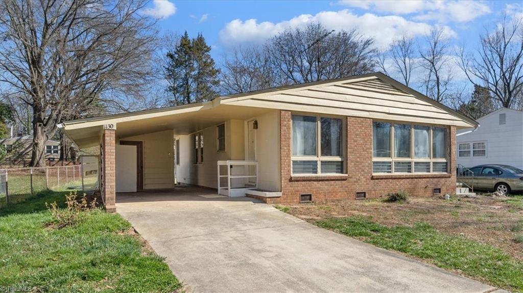 1130 Tabor Street High Point, NC 27262 - Photo 2 of 19 Wonderful bungalow home with large front yard, paved drive way, and carport.