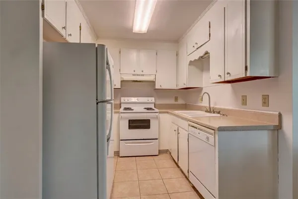 a kitchen with a white cabinets and white appliances