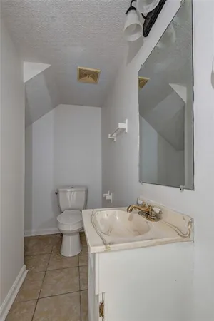 a bathroom with a sink toilet and mirror