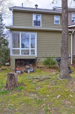 a view of a house with yard and sitting area