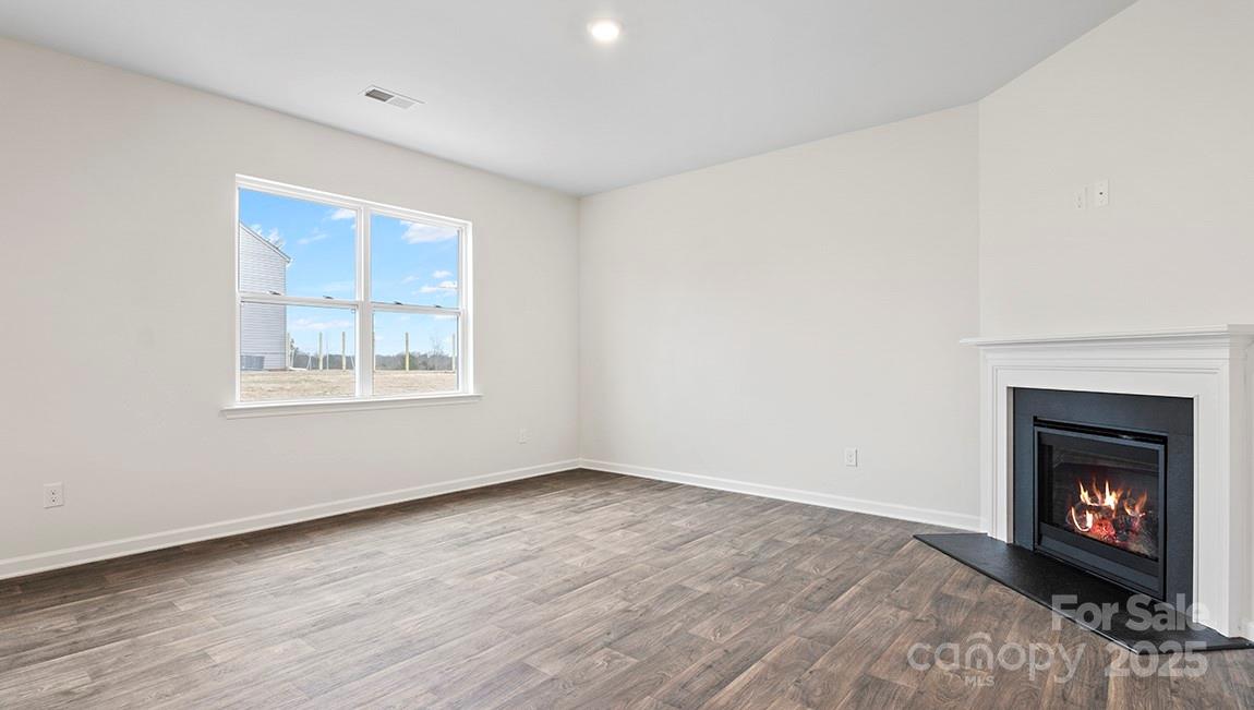 15 Shorthorn Road Fletcher, NC 28732 - Photo 17 of 34 an empty room with windows and fireplace