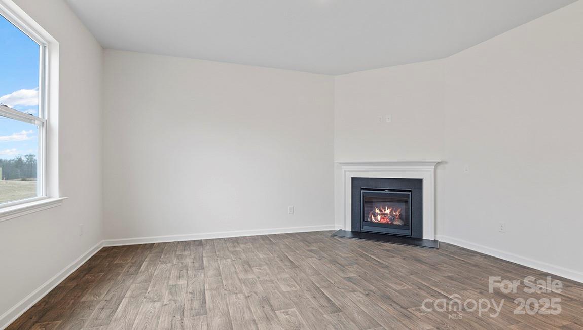 15 Shorthorn Road Fletcher, NC 28732 - Photo 18 of 34 a view of an empty room with a fireplace and a window