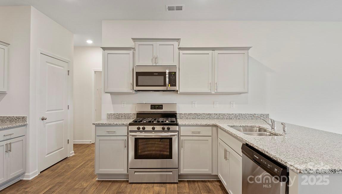 15 Shorthorn Road Fletcher, NC 28732 - Photo 5 of 34 a kitchen with cabinets stainless steel appliances and a counter space