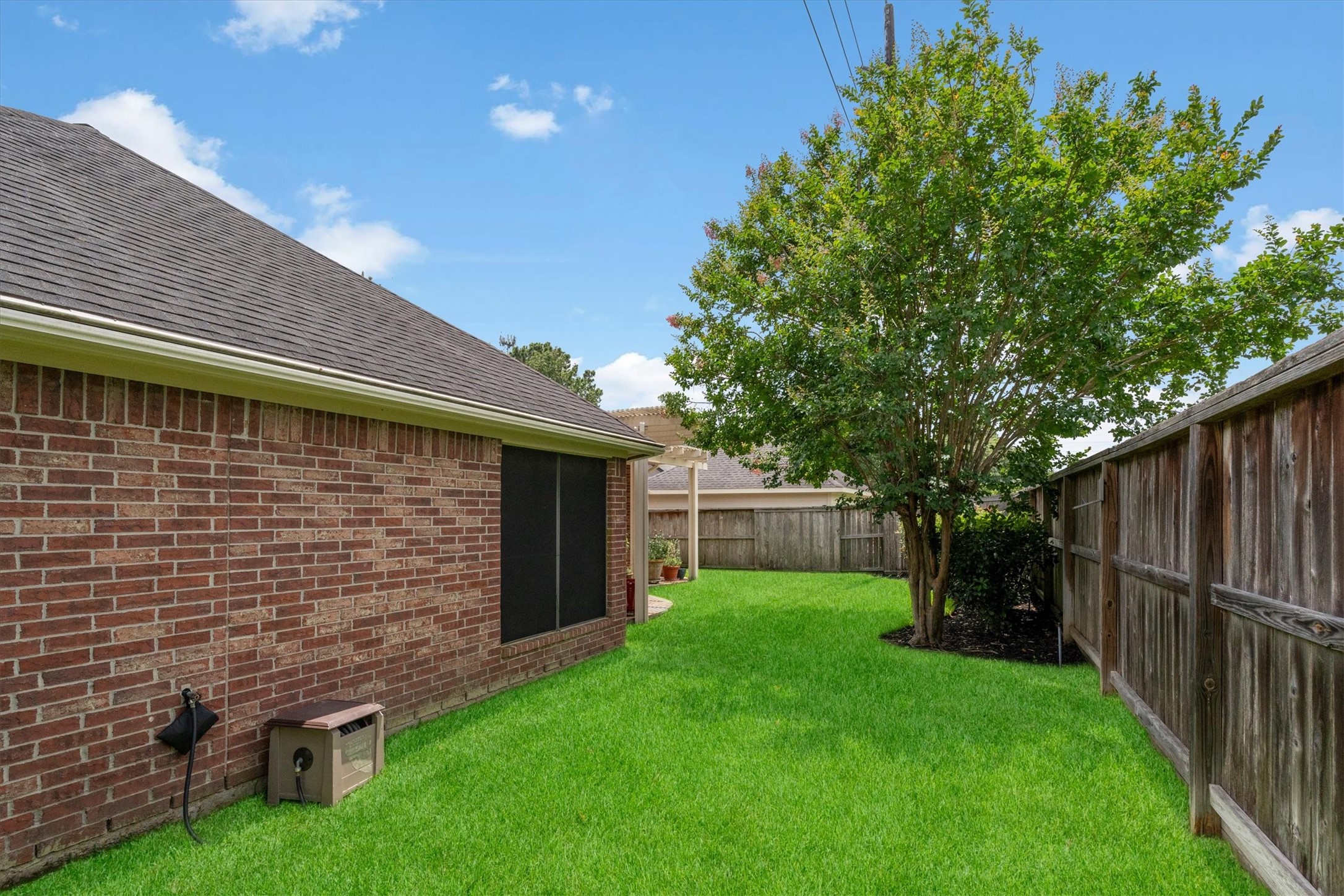 9406 Lochflora Drive Spring, TX 77379 - Photo 36 of 49 a backyard of a house with lots of green space