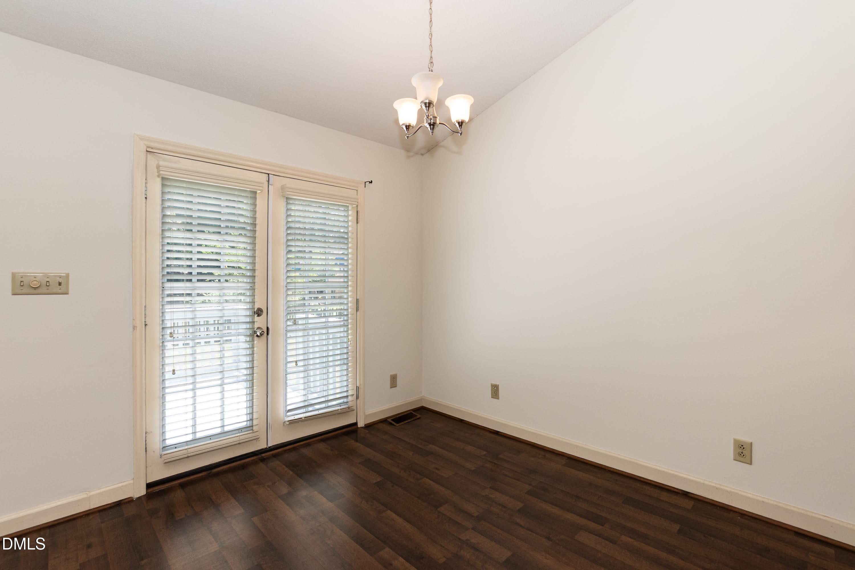 5604 Spring Pines Way Raleigh, NC 27616 - Photo 5 of 22 an empty room with wooden floor and windows