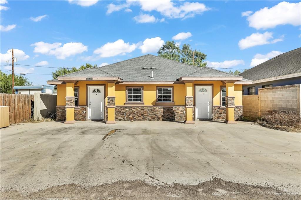 186 Benwood Road Rio Grande City, TX 78582 - Photo 2 of 12 a front view of a house with a yard and potted plants