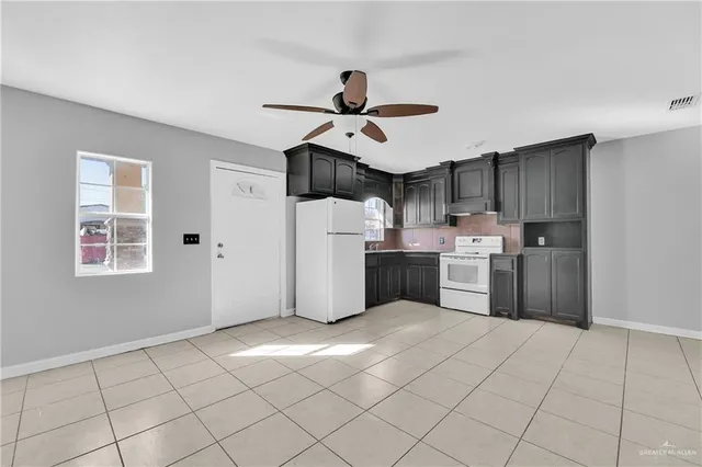 a kitchen with stainless steel appliances a sink and cabinets