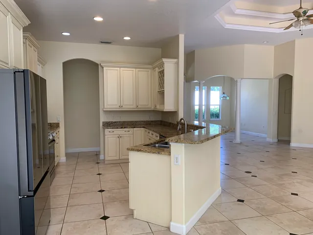 a kitchen with a sink cabinets and refrigerator