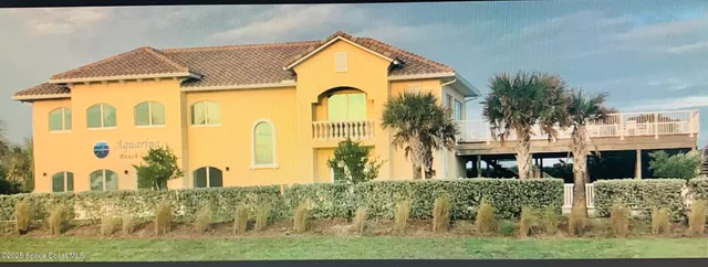 a front view of residential houses with outdoor space and trees