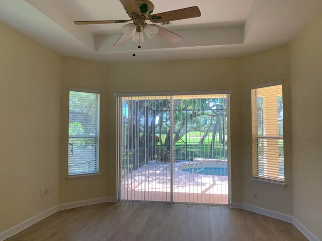 a view of a livingroom with a ceiling fan and window