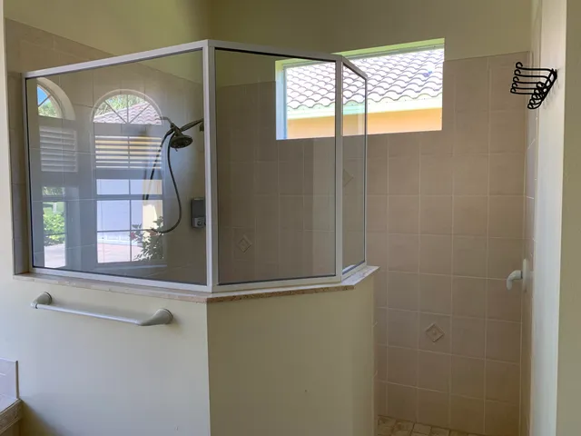 a bathroom with a window and a shower