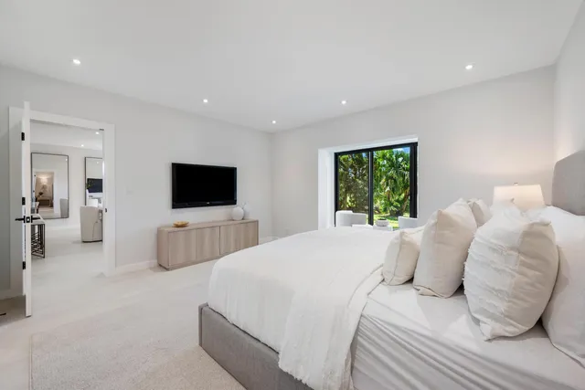 a bedroom with a bed and a flat screen tv