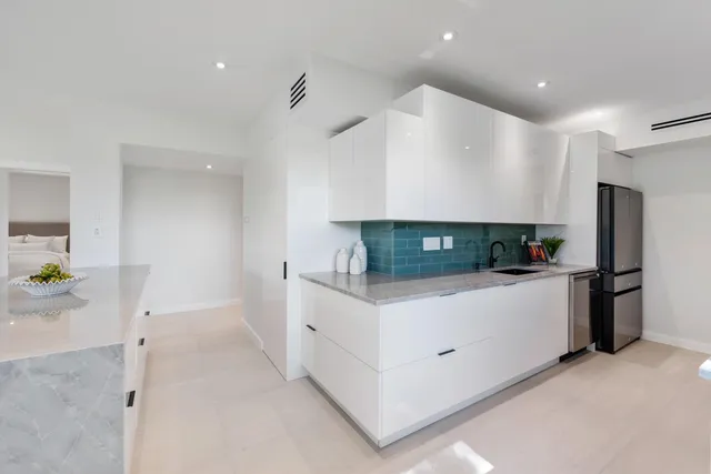 a kitchen with stainless steel appliances a refrigerator sink and stove