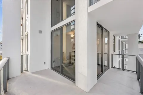 a spacious bathroom with a double vanity sink a mirror and a toilet