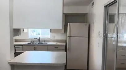 a kitchen with stainless steel appliances a refrigerator and a sink