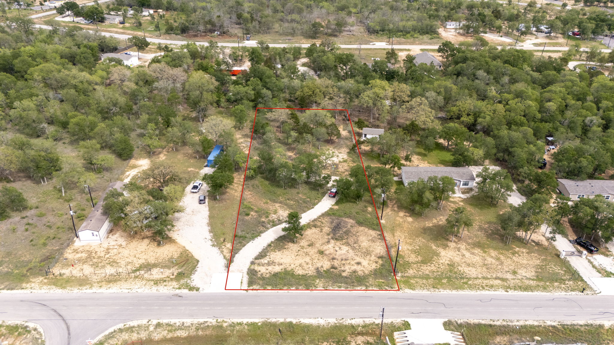 171 Comancheria Trail Elgin, TX 78621 - Photo 3 of 24 Aerial view of property and surrounding area with property boundaries highlighted