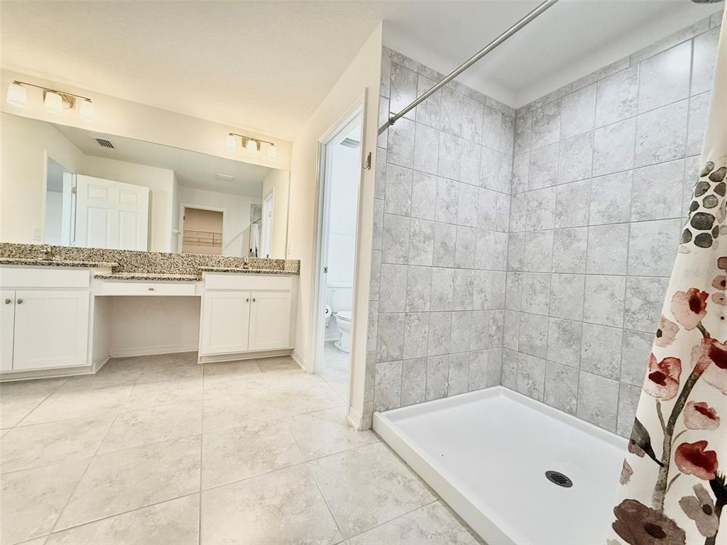 12189 Nouveau Avenue Spring Hill, FL 34610 - Photo 30 of 50 a bathroom with a tub a sink and a shower
