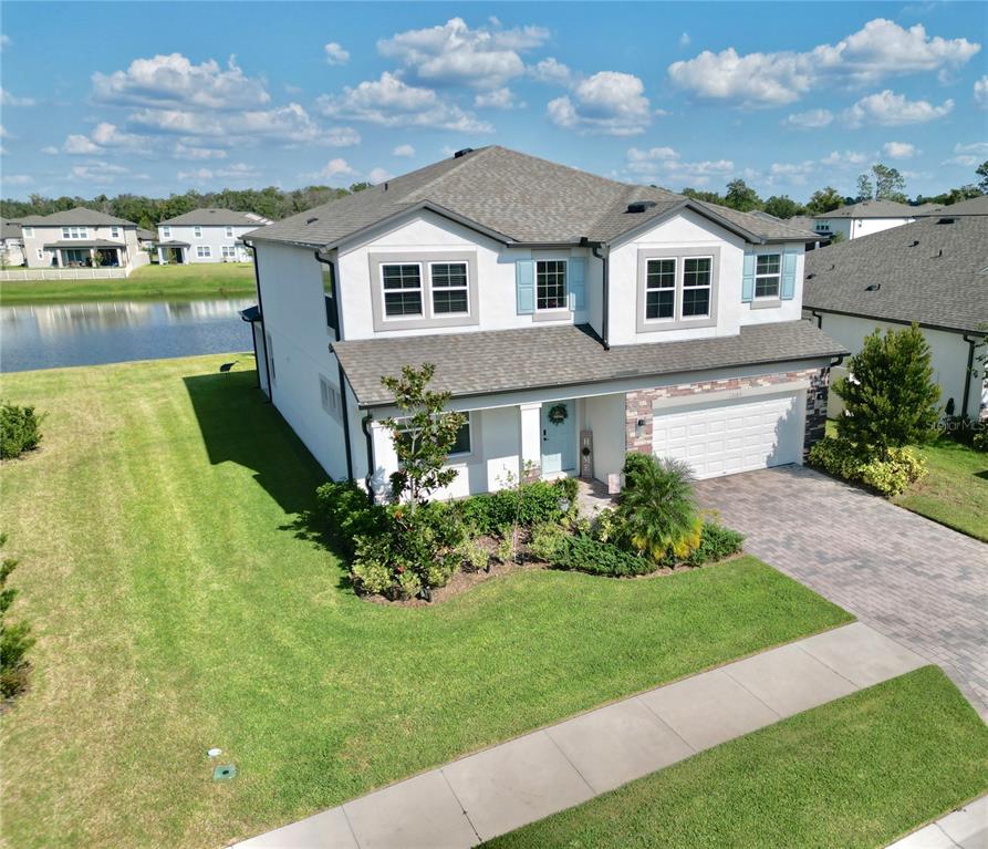 12189 Nouveau Avenue Spring Hill, FL 34610 - Photo 3 of 50 a front view of a house with a yard