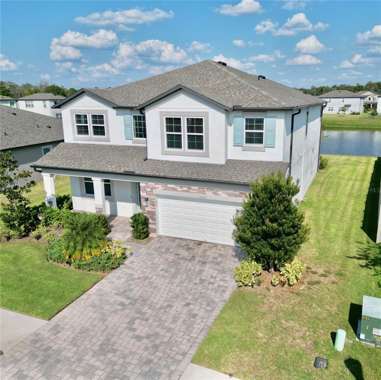 12189 Nouveau Avenue Spring Hill, FL 34610 - Photo 4 of 50 a front view of a house with garden